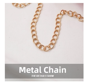 Close-up of elegant gold hardware chain detail on a stylish girls crossbody bag