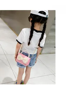 Pink girl's mini handbag with pearl bow details and golden chain strap for kids