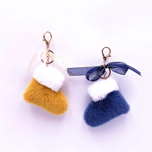 Cute plush Christmas boot keychains in yellow and blue with white fur and bow accents