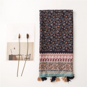 Detailed close-up of navy floral cotton scarf with ethnic pattern and fringed tassels