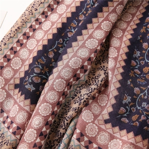 Detailed view of bohemian floral cotton scarf with intricate purple and beige patterns