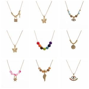 Collection of nine gold necklaces featuring zircon butterfly, lock, and evil eye pendants