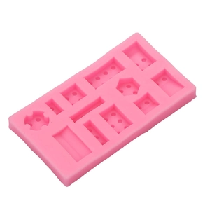 Pink Lego style silicone mold with various geometric slots for DIY baking and chocolate