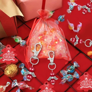 Red bead angel wing charms with red organza gift bag and festive holiday ornaments