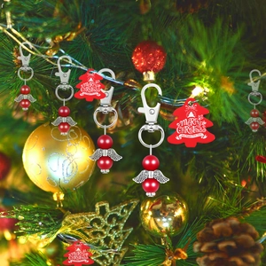 Christmas angel wing keychain with red beads, silver metal charms and festive tag