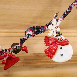 Hanging wooden Christmas tree decoration with snowmen, snowflakes, and berry accents