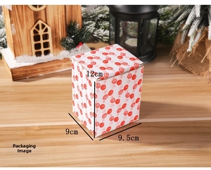 Detailed view of resin Christmas gift box with red floral patterns and 12cm dimensions