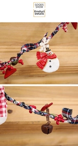 Detail of Christmas snowman pendant with metal bell, red berries and plaid fabric rope