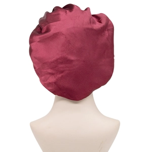 Burgundy satin sleep cap with wide elastic band for hair protection on white mannequin