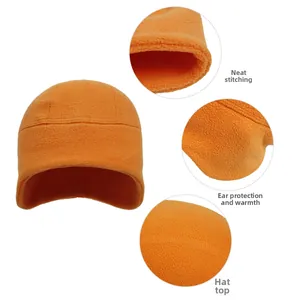 Detail view of orange fleece cycling beanie with ear protection and precision stitching