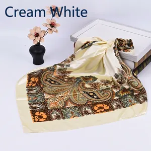 Close-up of off-white satin square scarf with vintage paisley patterns and floral prints