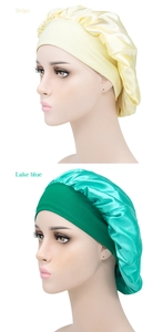 Detail of beige and lake blue satin sleep bonnets with wide elastic bands on models