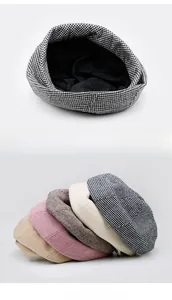 Detail view showing varied colors and interior lining of plaid knitted beret hats