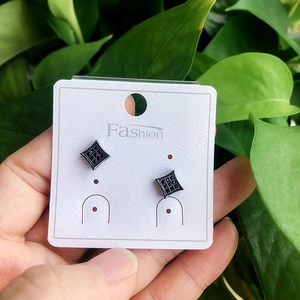 Matte black geometric square stud earrings with micro-inlaid AAA zircon on a display card