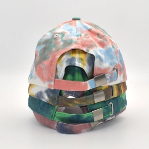 Detail of multi-color tie-dye baseball caps featuring adjustable silver metal buckles