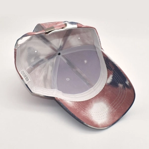 Detail of adjustable metal buckle and tie-dye cotton lining on a baseball cap