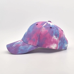 Detail view of the colorful tie-dye baseball cap featuring purple and blue cotton fabric