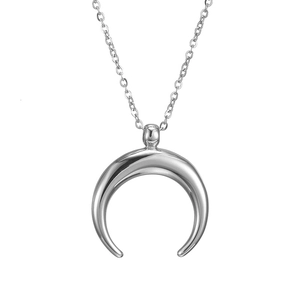 Macro shot of silver crescent moon pendant with sleek metallic finish on fine link chain