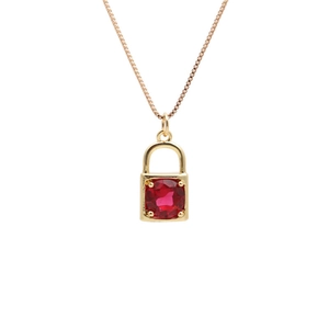 Golden necklace featuring a keyhole lock pendant with a vibrant red round zircon stone