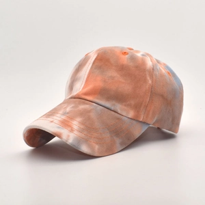 Macro detail of multi-color tie-dye cotton fabric and curved brim on a baseball cap