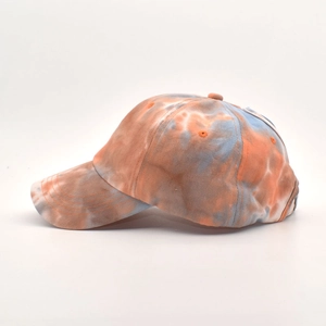 Detail of tie-dye baseball cap featuring reinforced visor stitching and breathable eyelets