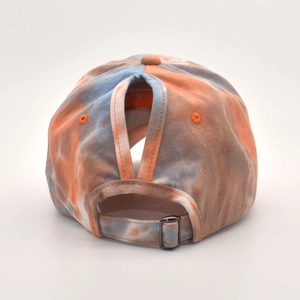 Detail view of tie-dye baseball cap with ponytail hole and adjustable metal buckle