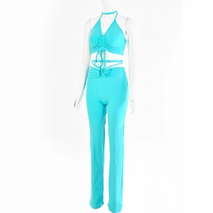 Detail of sky blue two-piece set featuring halter neck tie-up top and high waist pants