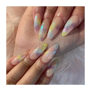 Iridescent stiletto false nails with glitter gradient on a soft pink plush background