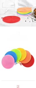 Close-up of colorful round silicone dish brushes with soft bristles and hanging loops