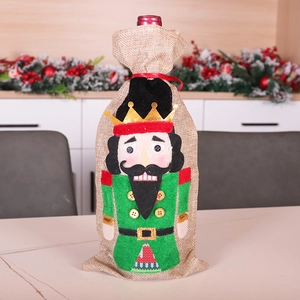 Christmas burlap wine bottle cover featuring Nutcracker soldier with festive ribbon