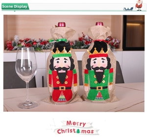 Close-up of nutcracker soldier wine bottle covers in red and green burlap fabric