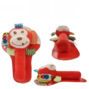 Front, side, and back views of a red monkey plush rattle with internal squeaker toy