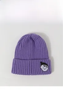Detailed texture of purple core-spun yarn beanie with cute cartoon character patch embroidery