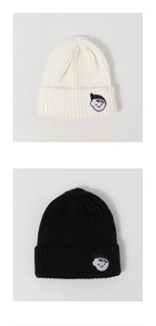 Close-up of knit ribbing and cartoon embroidery on cream and black beanies