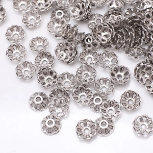Detailed macro view of silver flower bead caps for DIY jewelry and bracelet making