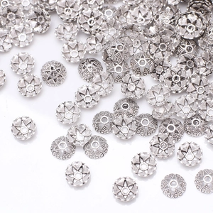 Macro shot of silver hollow petal spacer beads for DIY jewelry making accessories