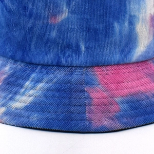 Detail of tie-dye corduroy bucket hat showing blue and pink texture and fine stitching