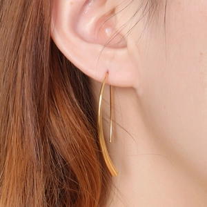 Minimalist gold-plated curved linear earrings shown on a model for a modern look