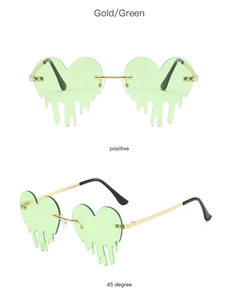 Detail of green heart-shaped rimless sunglasses with gold metal temples and drip edge