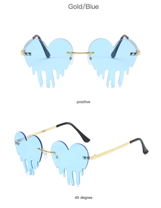 Close-up of heart-shaped rimless sunglasses with blue drip lenses and gold metal frames