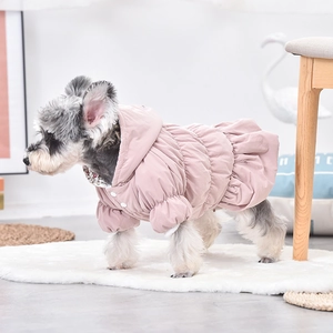 Detail of pink quilted dog winter coat with floral lining and snap button closure