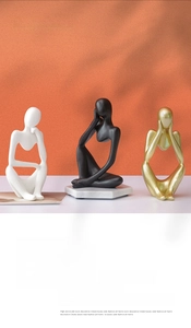 Three-piece modern abstract thinker figurines in black, white, and matte gold resin