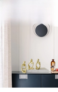 Close-up of golden abstract thinker statues in a three-piece set for modern home decor