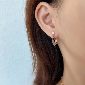 French style 925 sterling silver U-shaped twisted stud earrings worn by a model
