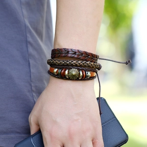 Close-up of three-piece vintage brown braided leather bracelet set with star charms