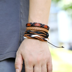 Detailed view of multilayer braided leather bracelets with adjustable drawstrings on a wrist