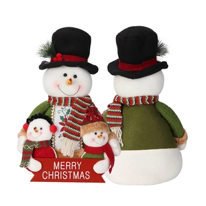 Detail showing plush snowman figurines holding a red Merry Christmas festive banner