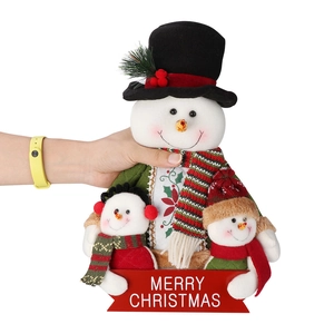Plush Christmas snowman trio with Merry Christmas sign held in hand to show scale