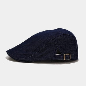 Detail of vintage navy denim ivy cap showing metal buckle and textured stitching