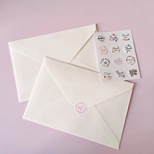 Set of 12 round Thank You adhesive stickers with floral designs for white envelope sealing